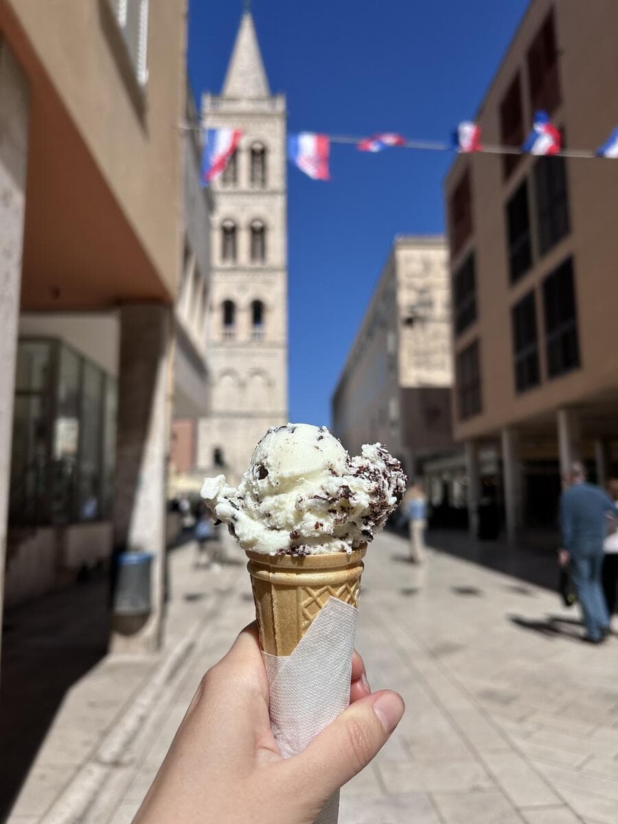 Ice cream cone in front of a Croatian church tower