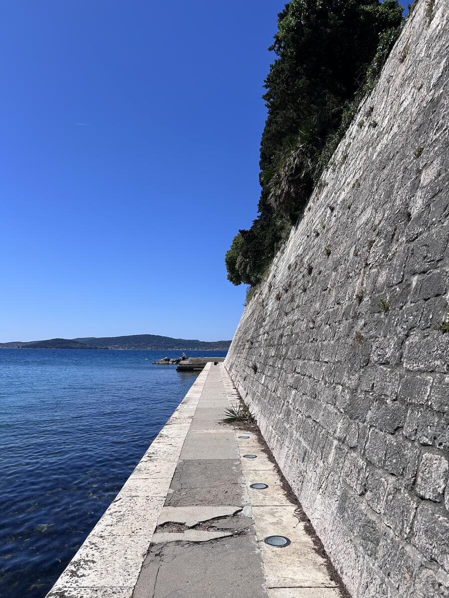 Stone sea wall with the Adriatic and islands beyond